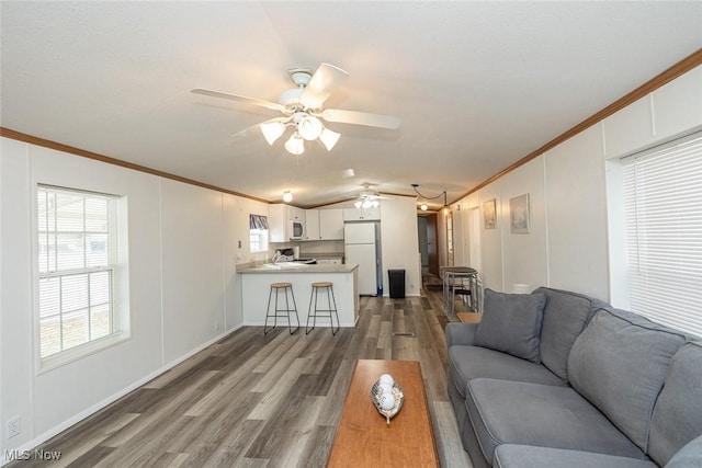 living room with crown molding, ceiling fan, lofted ceiling, and dark wood-type flooring