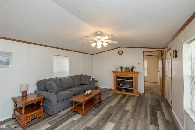 living room featuring crown molding, ceiling fan, lofted ceiling, and dark wood-type flooring