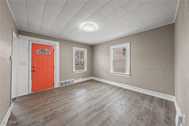 foyer entrance featuring crown molding and hardwood / wood-style floors