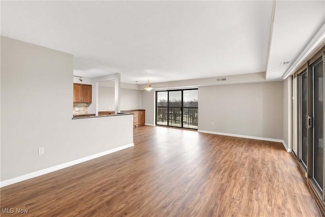 unfurnished living room featuring hardwood / wood-style flooring