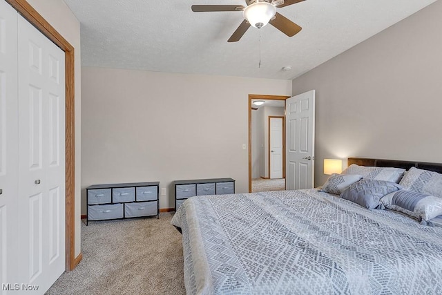 bedroom with a textured ceiling, baseboards, a ceiling fan, and light colored carpet