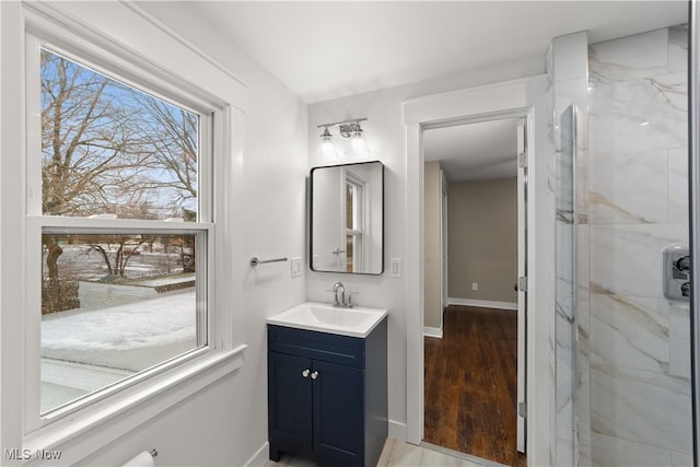 bathroom with vanity, wood-type flooring, and walk in shower