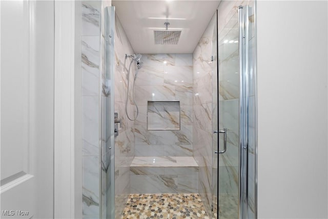 bathroom with a shower with door