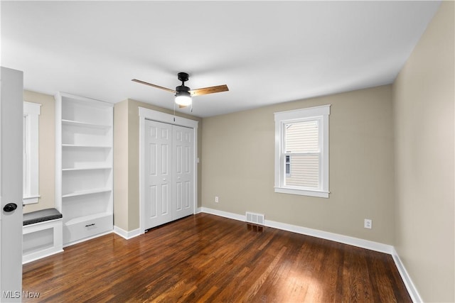 unfurnished bedroom with dark hardwood / wood-style floors and ceiling fan