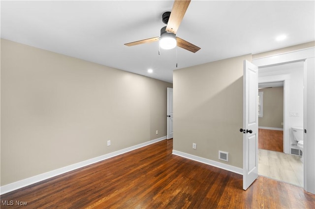 spare room featuring dark hardwood / wood-style floors and ceiling fan