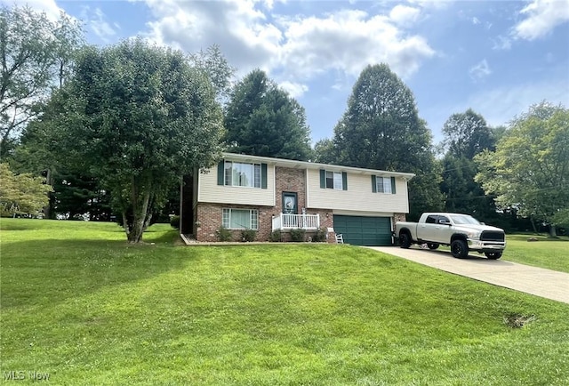 raised ranch with a garage and a front yard