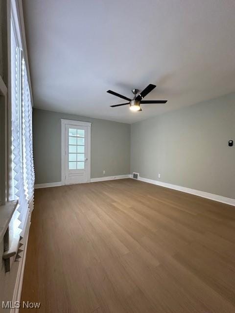 empty room with hardwood / wood-style flooring and ceiling fan