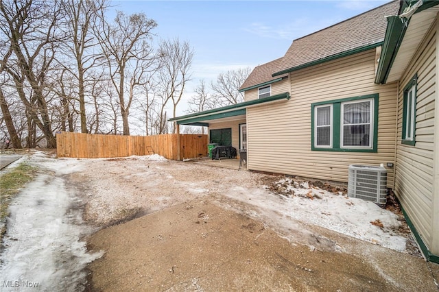 snow covered property with cooling unit