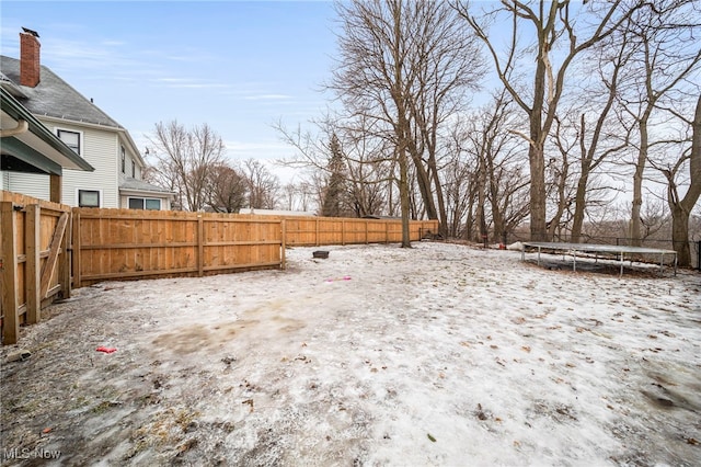 snowy yard with a trampoline