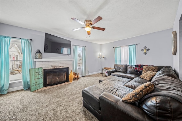 carpeted living room featuring ceiling fan, a fireplace, and a textured ceiling