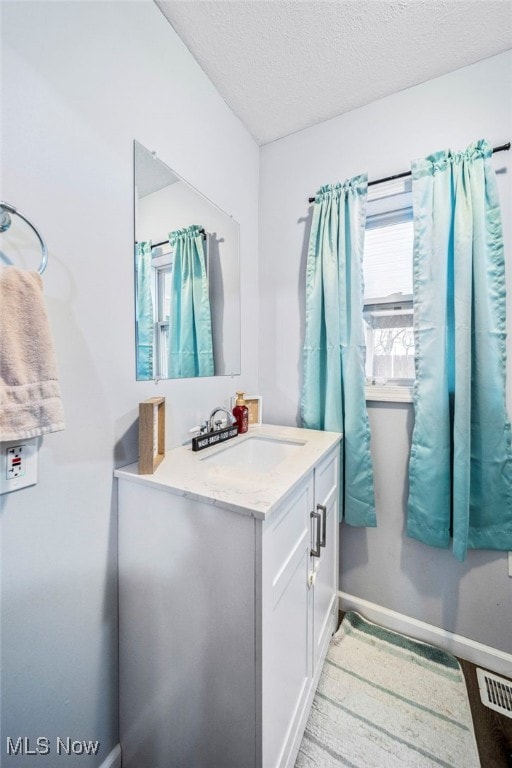 bathroom featuring vanity and a textured ceiling