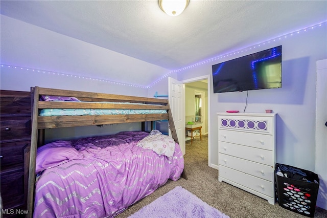 bedroom with vaulted ceiling, carpet, and a textured ceiling