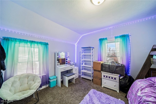 bedroom featuring vaulted ceiling, a textured ceiling, and dark colored carpet