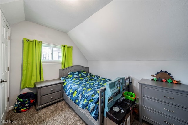 carpeted bedroom with vaulted ceiling