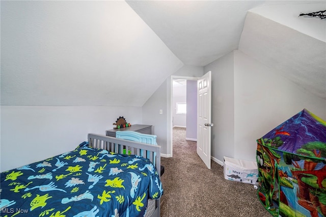 carpeted bedroom with lofted ceiling