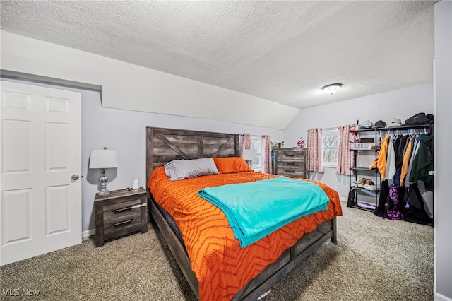 carpeted bedroom featuring vaulted ceiling and a textured ceiling