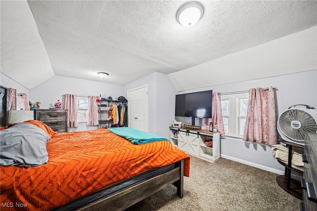 bedroom with multiple windows, vaulted ceiling, and carpet flooring