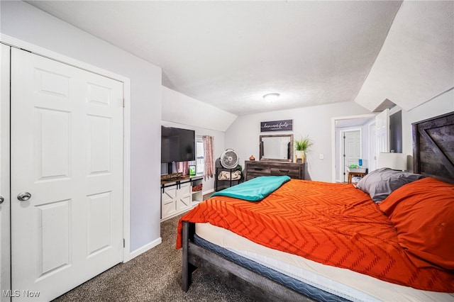 carpeted bedroom with vaulted ceiling