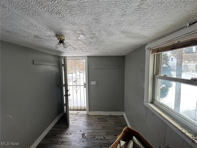 foyer with dark hardwood / wood-style floors and a textured ceiling