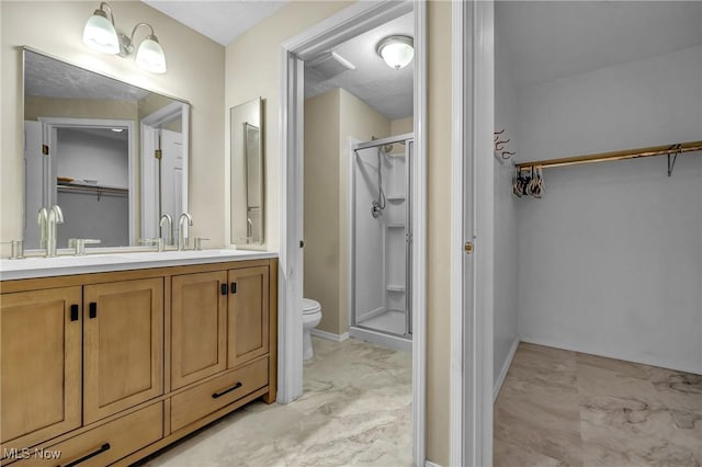 bathroom with vanity, an enclosed shower, and toilet