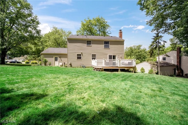 back of house with a wooden deck and a yard