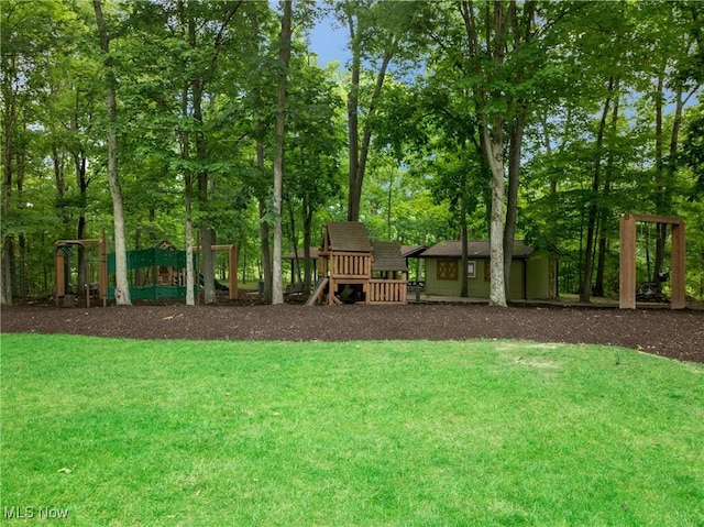 view of yard with an outdoor structure and a playground