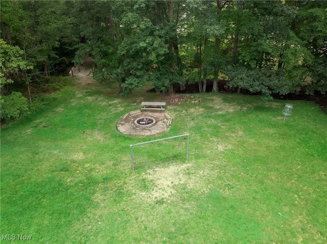 view of yard with a fire pit