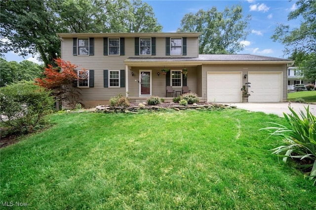 view of front of home featuring a garage, a front yard, and covered porch