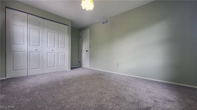 unfurnished bedroom featuring carpet and a closet