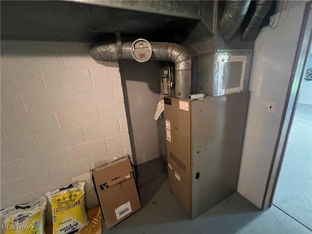 utility room featuring heating unit