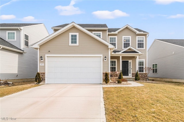 view of front of home featuring a garage and a front lawn