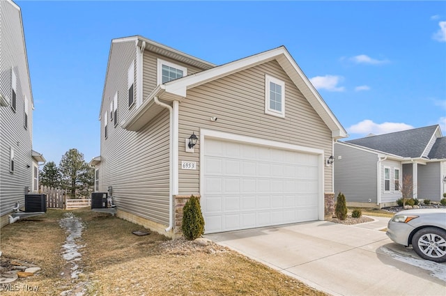 view of property exterior featuring central AC and a garage