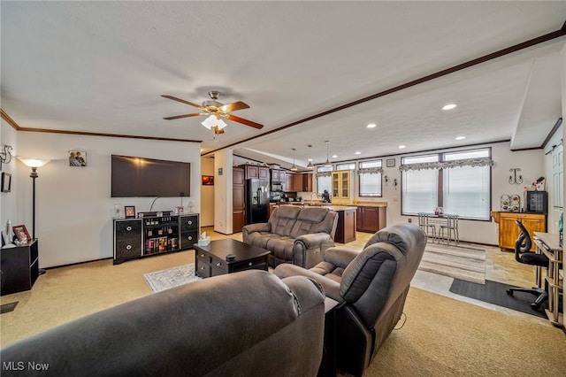 living room with crown molding, light colored carpet, and ceiling fan