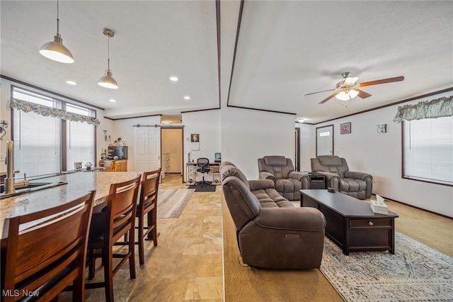 living room with crown molding, ceiling fan, and sink