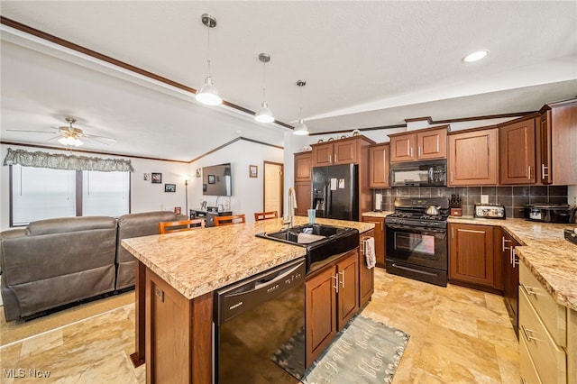 kitchen with sink, a kitchen island with sink, black appliances, decorative backsplash, and decorative light fixtures