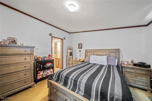 carpeted bedroom featuring ornamental molding, a textured ceiling, and ensuite bathroom