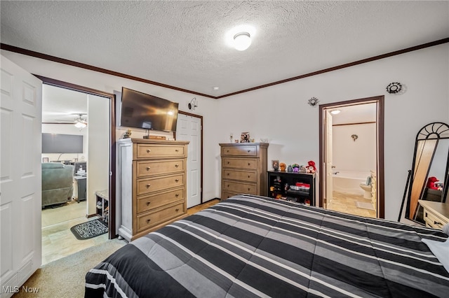 bedroom featuring ornamental molding, connected bathroom, light carpet, and a textured ceiling