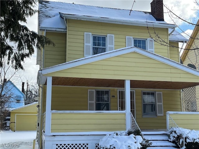 view of front of property featuring a garage and an outdoor structure