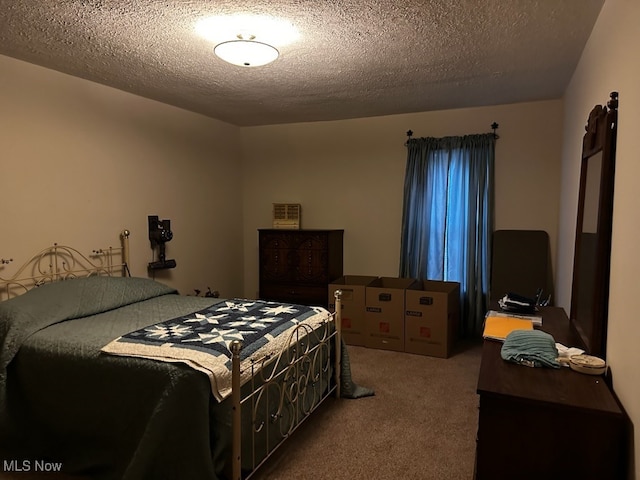 bedroom with a textured ceiling and carpet floors