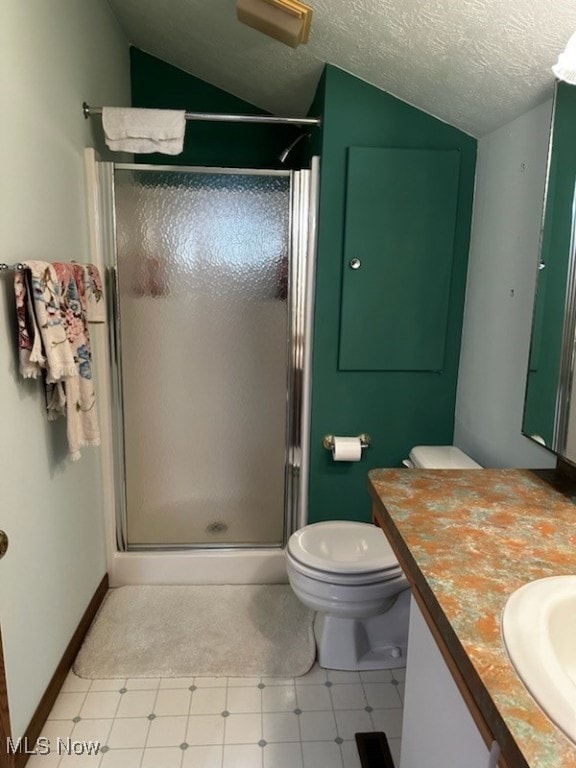 bathroom with lofted ceiling, tile patterned floors, a textured ceiling, vanity, and a shower stall