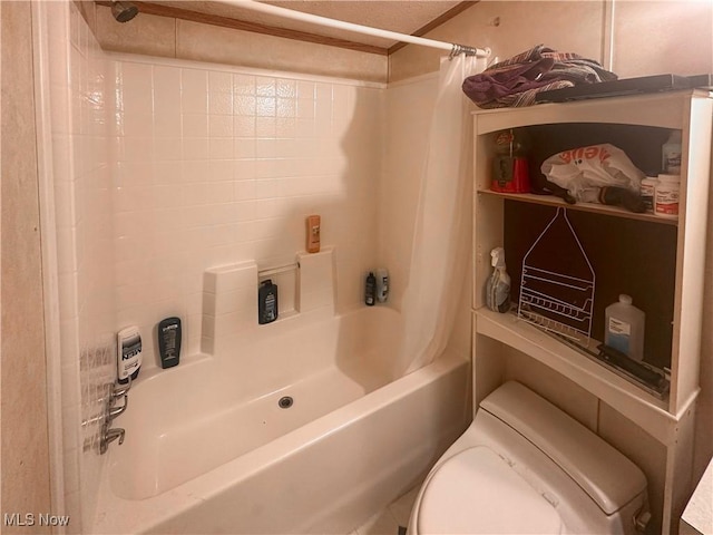 bathroom with shower / tub combo and toilet