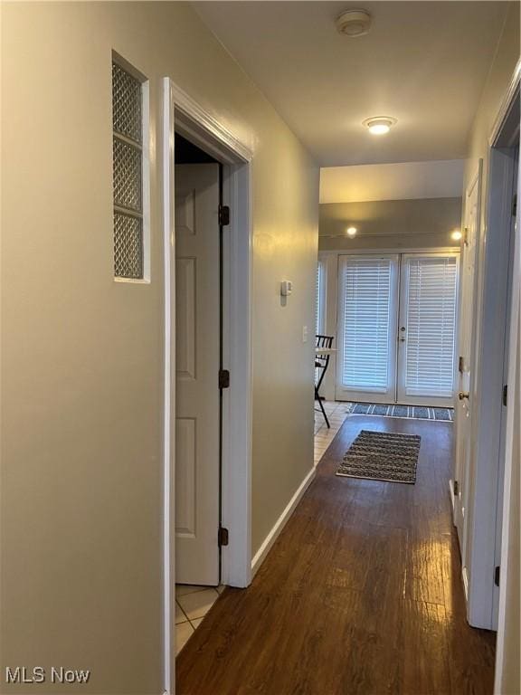 hallway with hardwood / wood-style flooring