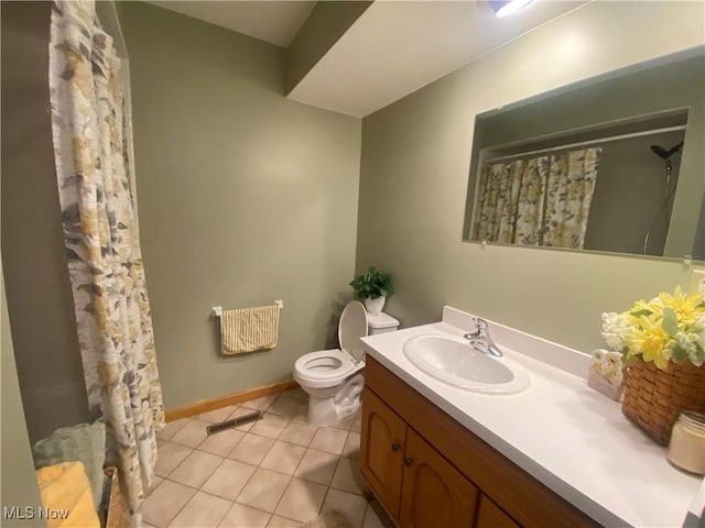 bathroom with tile patterned floors, vanity, toilet, and curtained shower