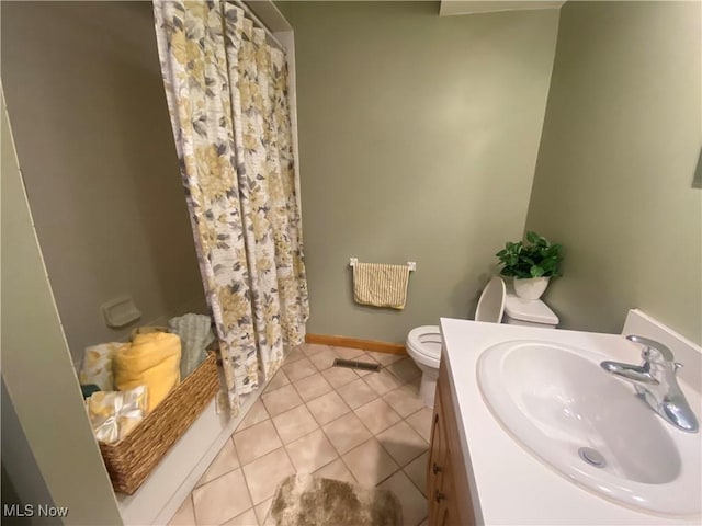 bathroom featuring vanity, tile patterned floors, and toilet