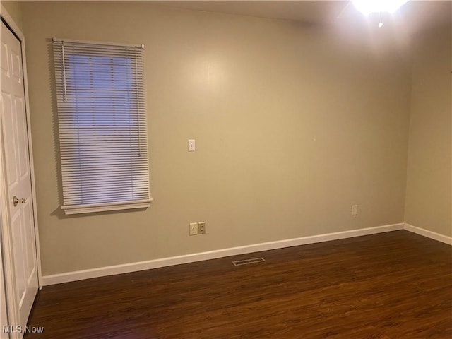 empty room with dark wood-type flooring