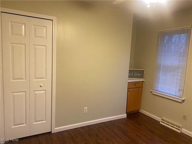 spare room featuring dark hardwood / wood-style flooring