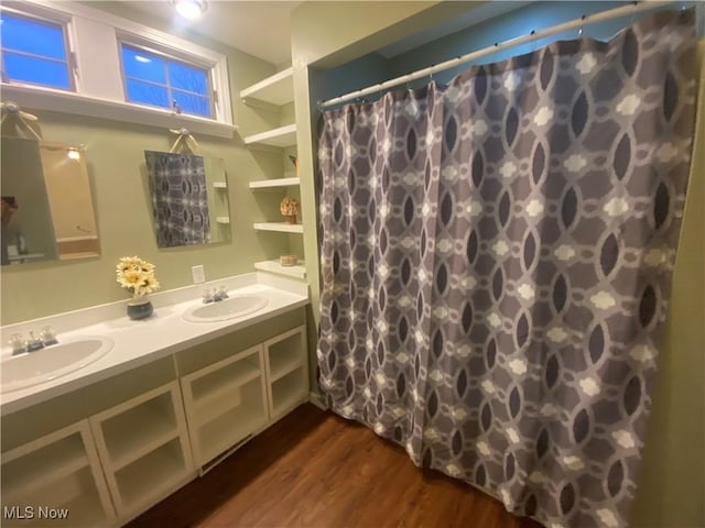 bathroom with a shower with shower curtain, vanity, and hardwood / wood-style floors