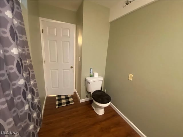 bathroom featuring hardwood / wood-style flooring and toilet