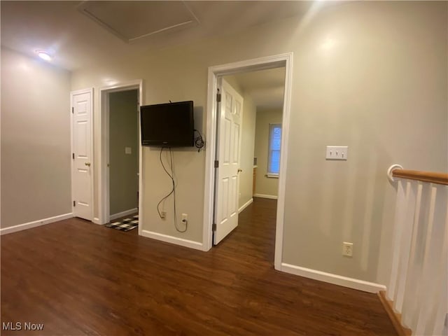 unfurnished room with dark hardwood / wood-style flooring