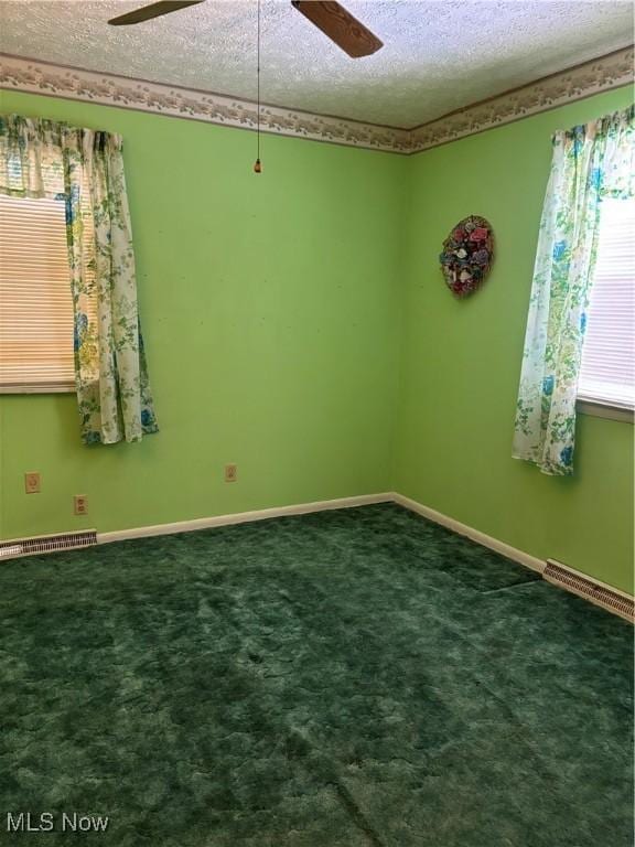 unfurnished room featuring a textured ceiling, ceiling fan, and carpet flooring